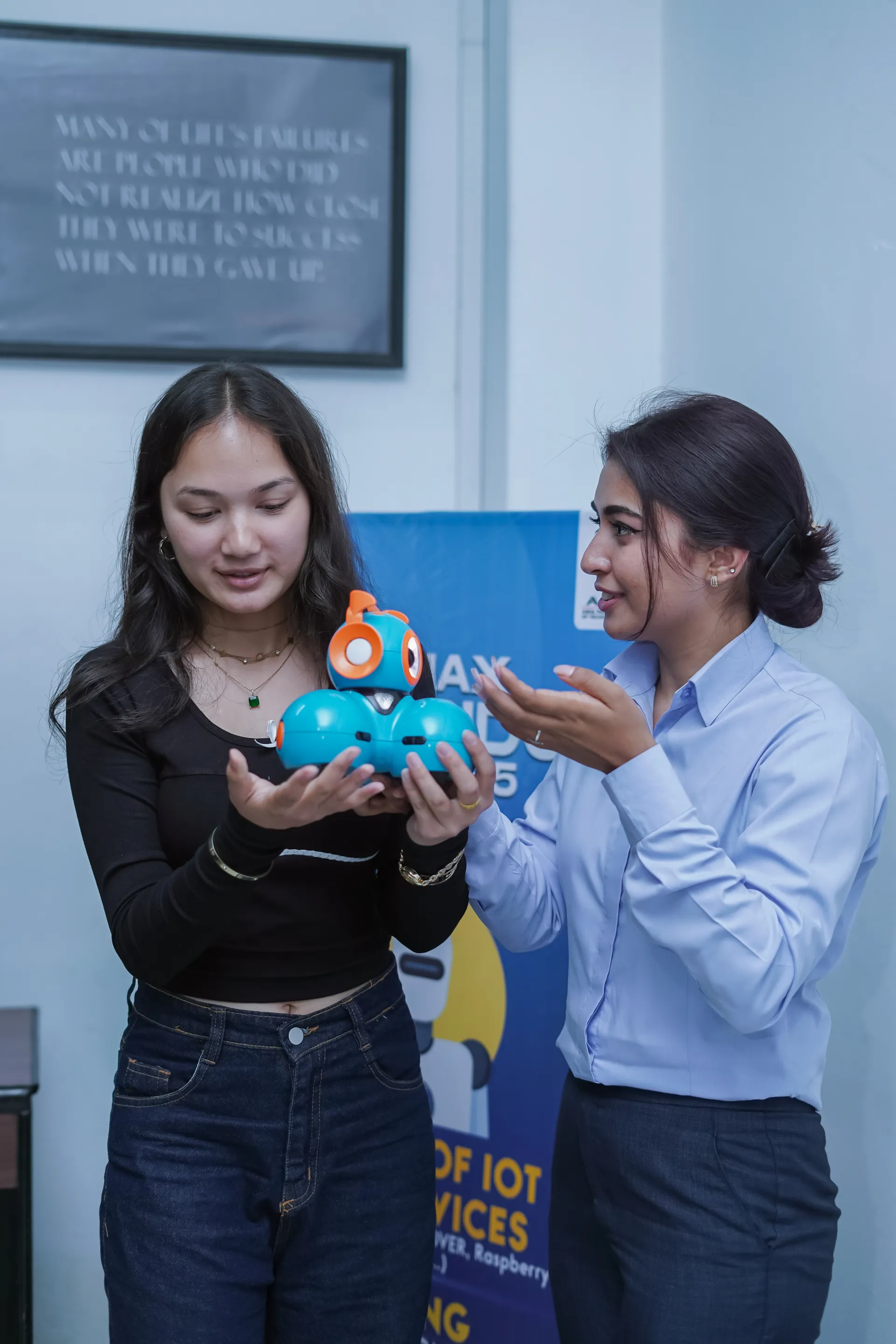 Two girls holding robot