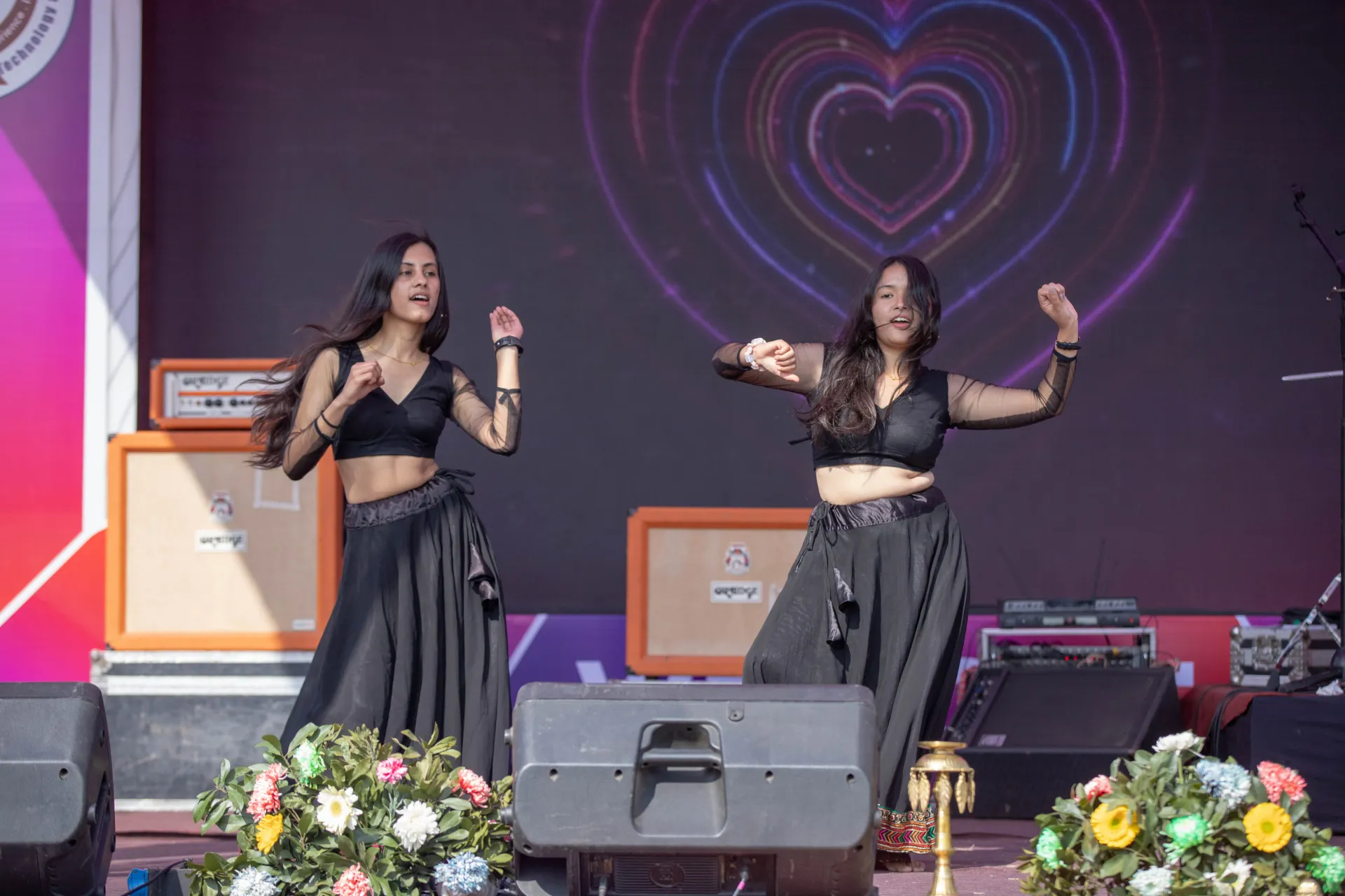 A boy and a girl dancing in stage wearing traditional clothes