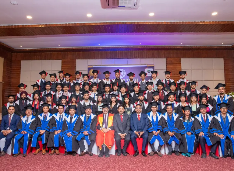 Bunch of students wearing academic regalia sitting in rows
