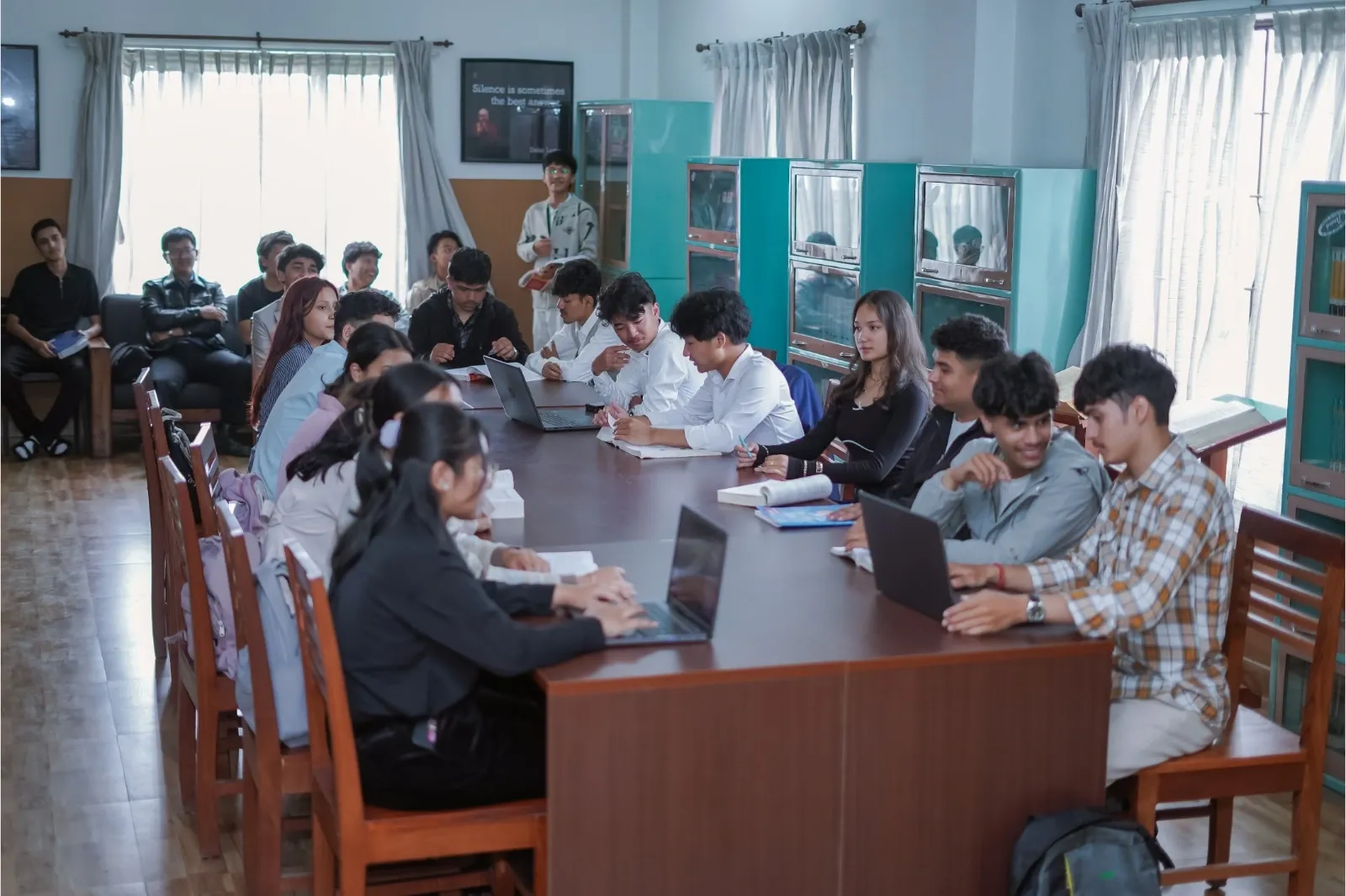 Students sitting and reading books at library