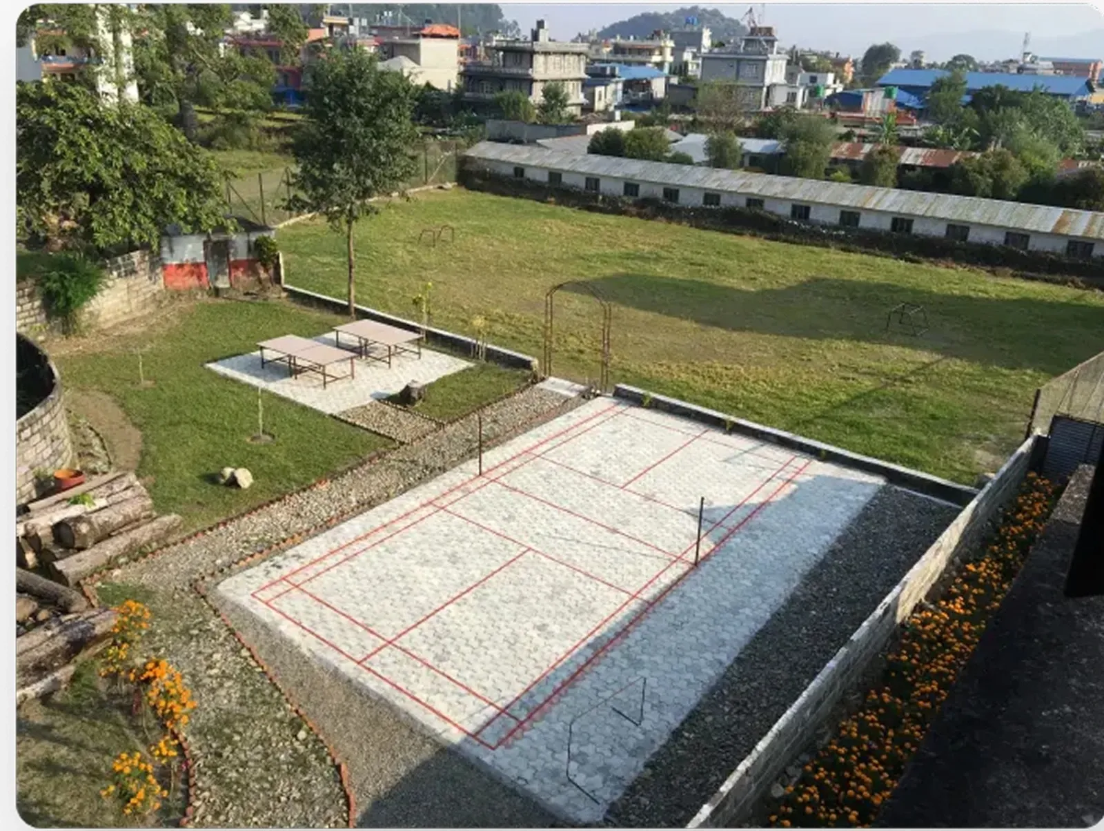 Top view of a playground containing badminton court, table tennis and football ground